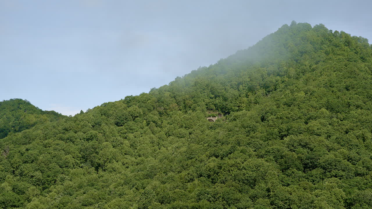 Cinematic drone footage revealing hazy ridgelines