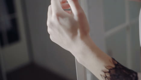 the girl is dressed in a robe and underwear. beautiful girl in underwear near a white wall.
