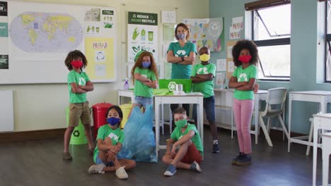 Female-teacher-and-group-of-kids-wearing-recycle-symbol-t-shirt-in-class