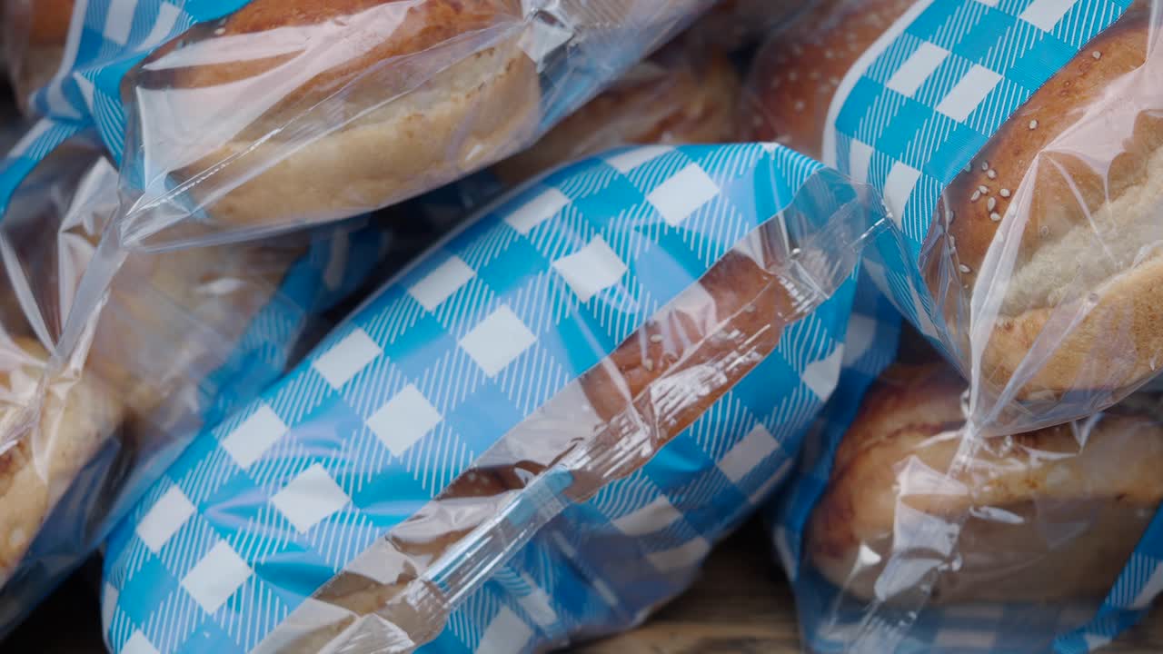 Freshly Baked Bread Loaves Wrapped in Checkered Plastic Bags