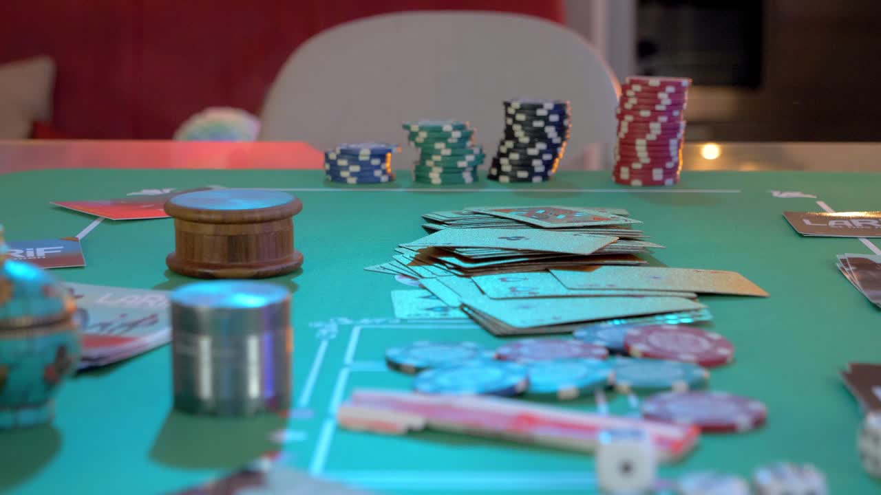 slow pull out shot of poker chips, playing cards and dicer left on a poker table