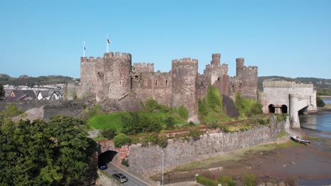 aerial perspective of a medieval castle and suspension bridge in conwy, wales