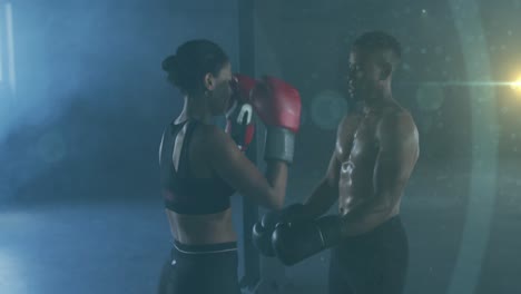 animación de puntos brillantes sobre hombre y mujer boxeando, haciendo ejercicio en el gimnasio