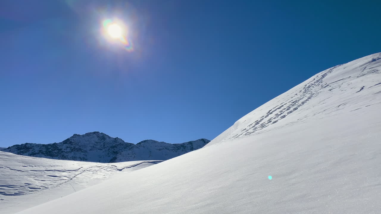 A sunny winter day in the mountains, a lot of snow, a blue sky, on the top, scenic view.