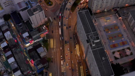 hong kong night-time topdown panoramic view, evening traffic, freeway, roads, cars, highway, rainbow estate, residential building, rush hour, asia, modern city, fast environment, public transportation