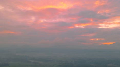 Timelapse,-clouds-moving-across-the-sky-at-sunrise-with-orange-and-yellow-colors