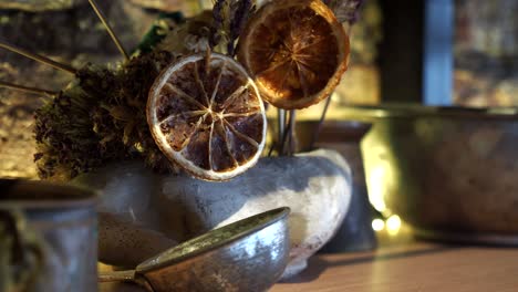 dried flower arrangement with dried citrus and vintage copper utensils