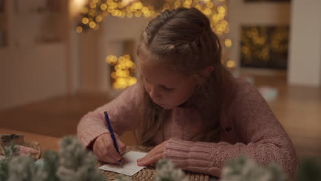 Little-Girl-Writes-A-Christmas-Letter-To-Santa-Claus-At-Home,-Thinking-And-Dreaming