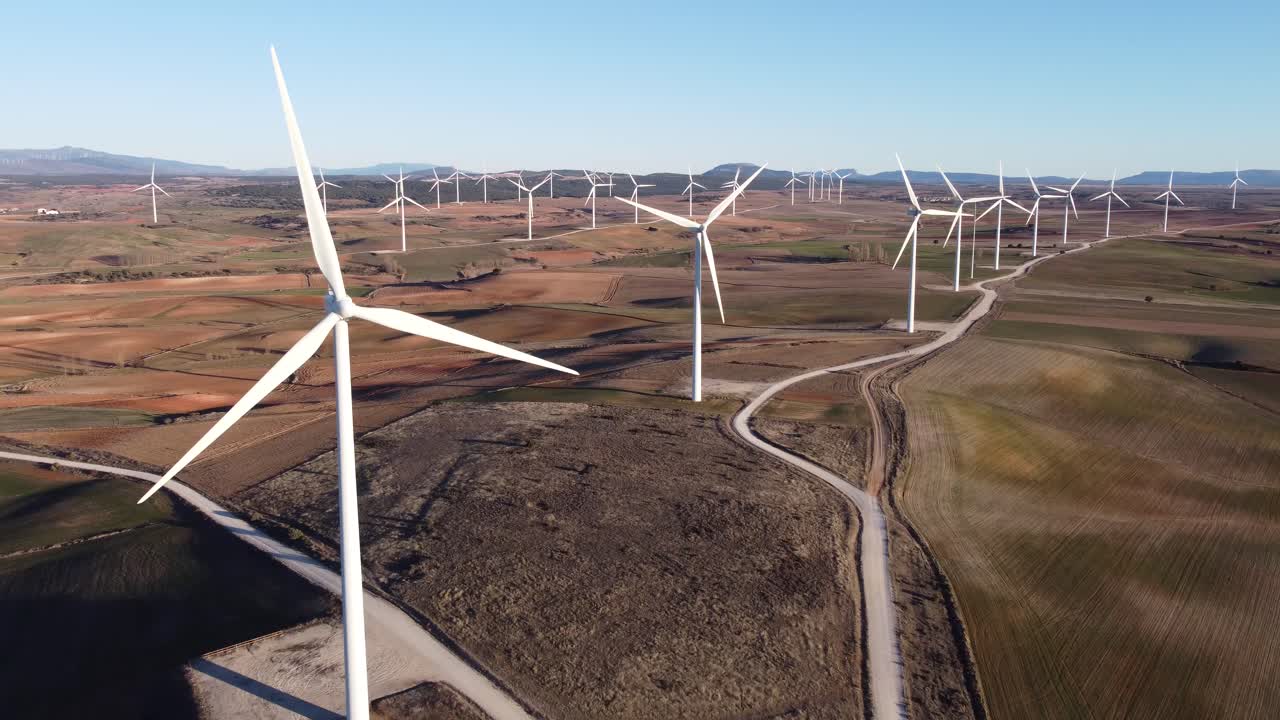 Windmills in field on sunny day