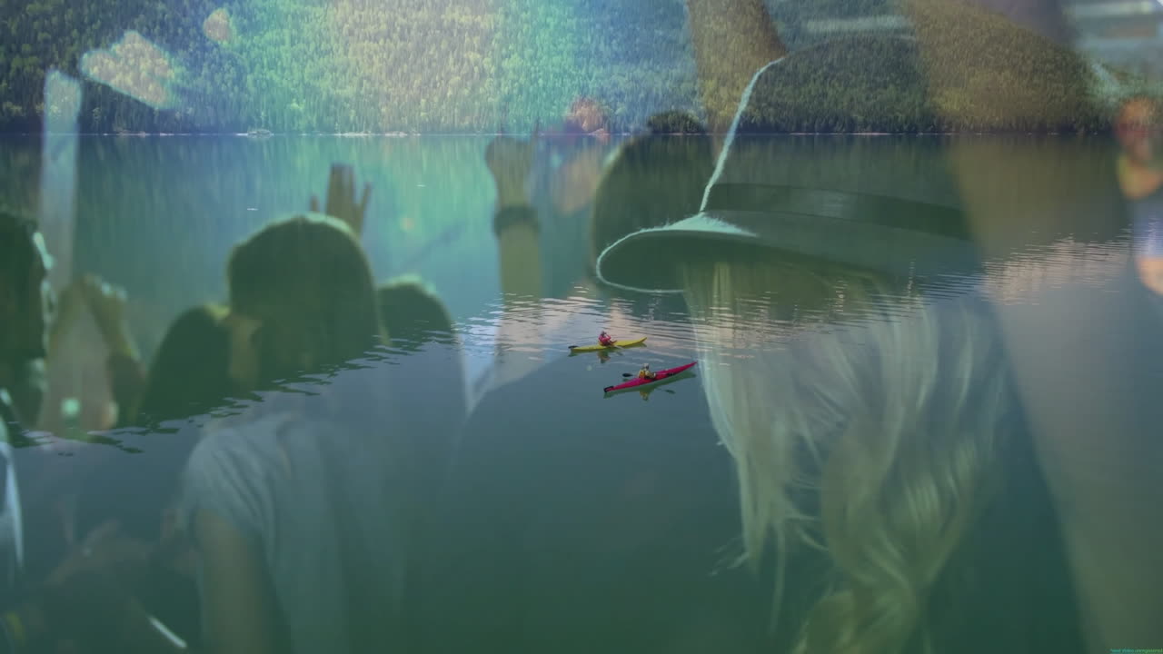 Kayakers paddling on lake in travel ad, with translucent crowd raising smartphones and bucket hat