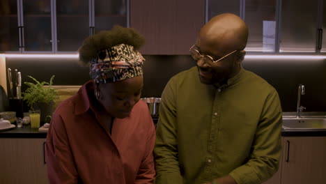 mature couple playing in the kitchen