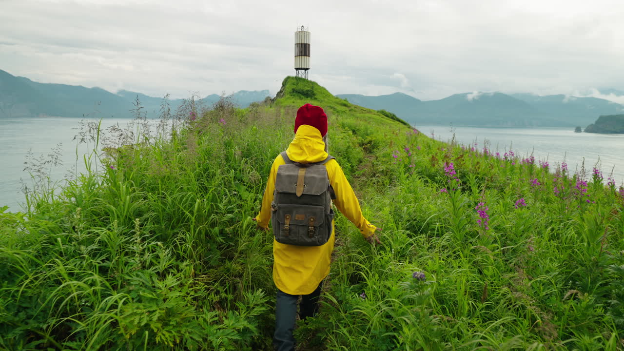 Woman Hiking on Coastal Path with Lighthouse View
