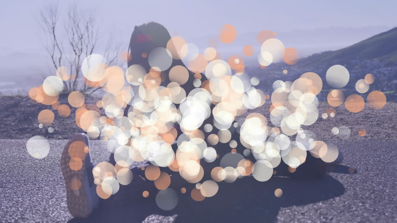 Stretching on road, person surrounded by bokeh light animation, exercising outdoors