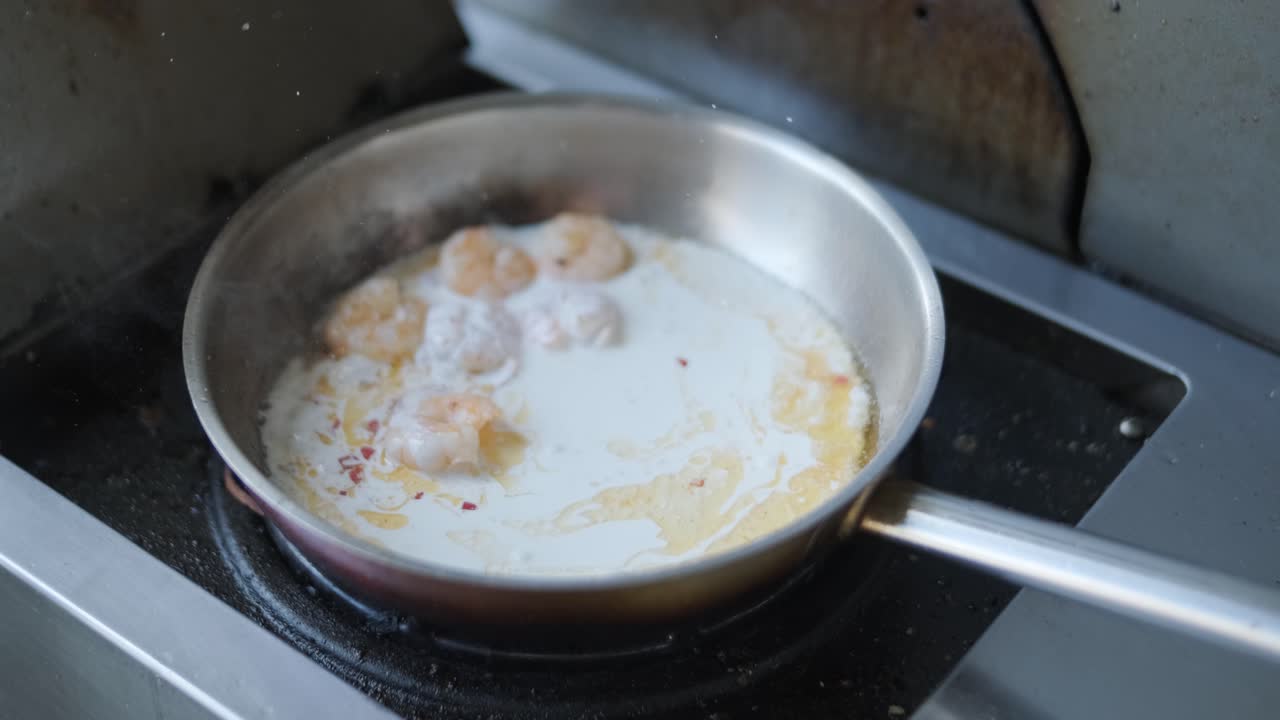 Koki Memasak Pasta dengan Udang di Panggangan Luar Ruangan
