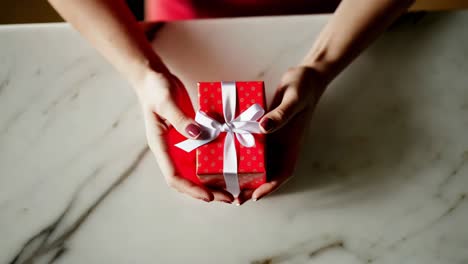 woman holding a red gift box