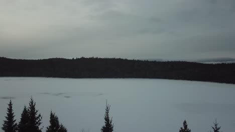 Vast-frozen-lake-wintery-trees-on-the-side-of-highway-in-Canada-Frozen-lake