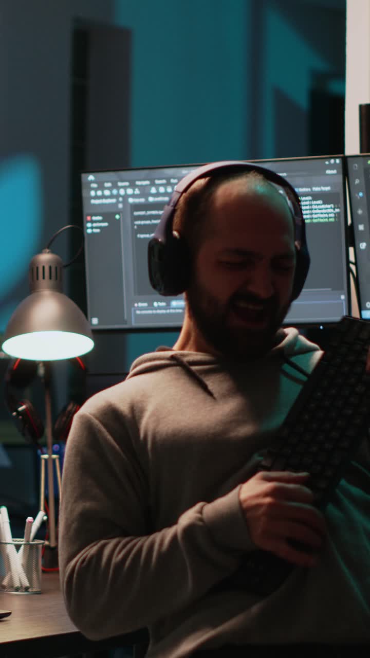 Vertical video: Careless html coder playing air guitar with keyboard