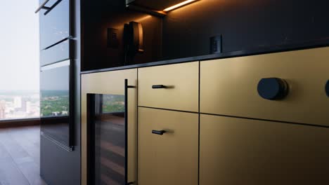 Close-up-shot-of-a-modern-stylish-kitchen-with-black-and-gold-accented-wine-fridge-and-stove