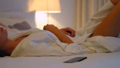 Woman-relaxing-on-bed-in-bedroom-4k