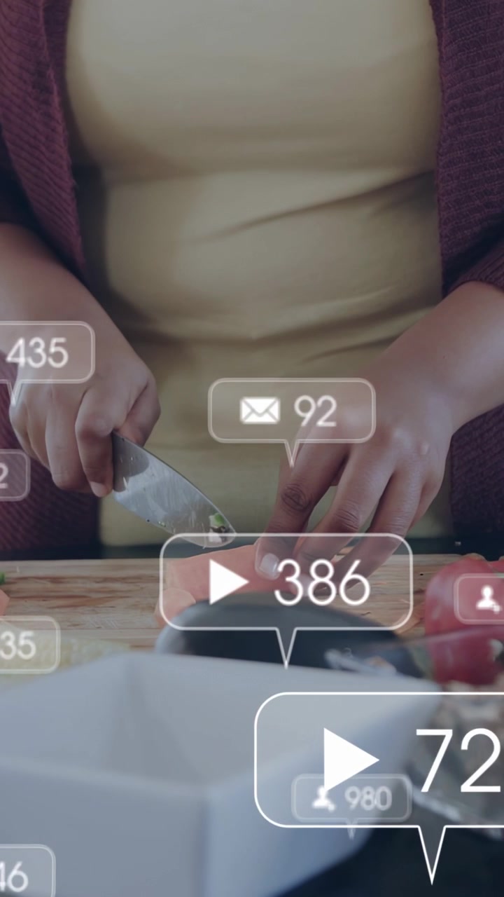 Vertical video: Start woman chopping veg on board for cooking then pausing while bubbles over hands