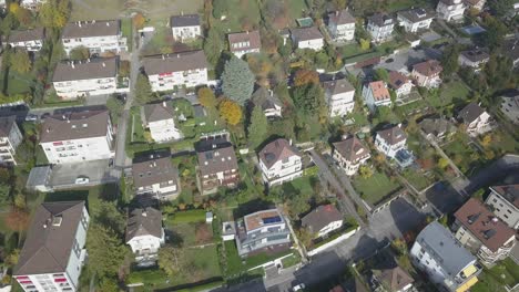 drone panning aerial view: residential neighborhood in a lausanne: houses ,buildings and trees