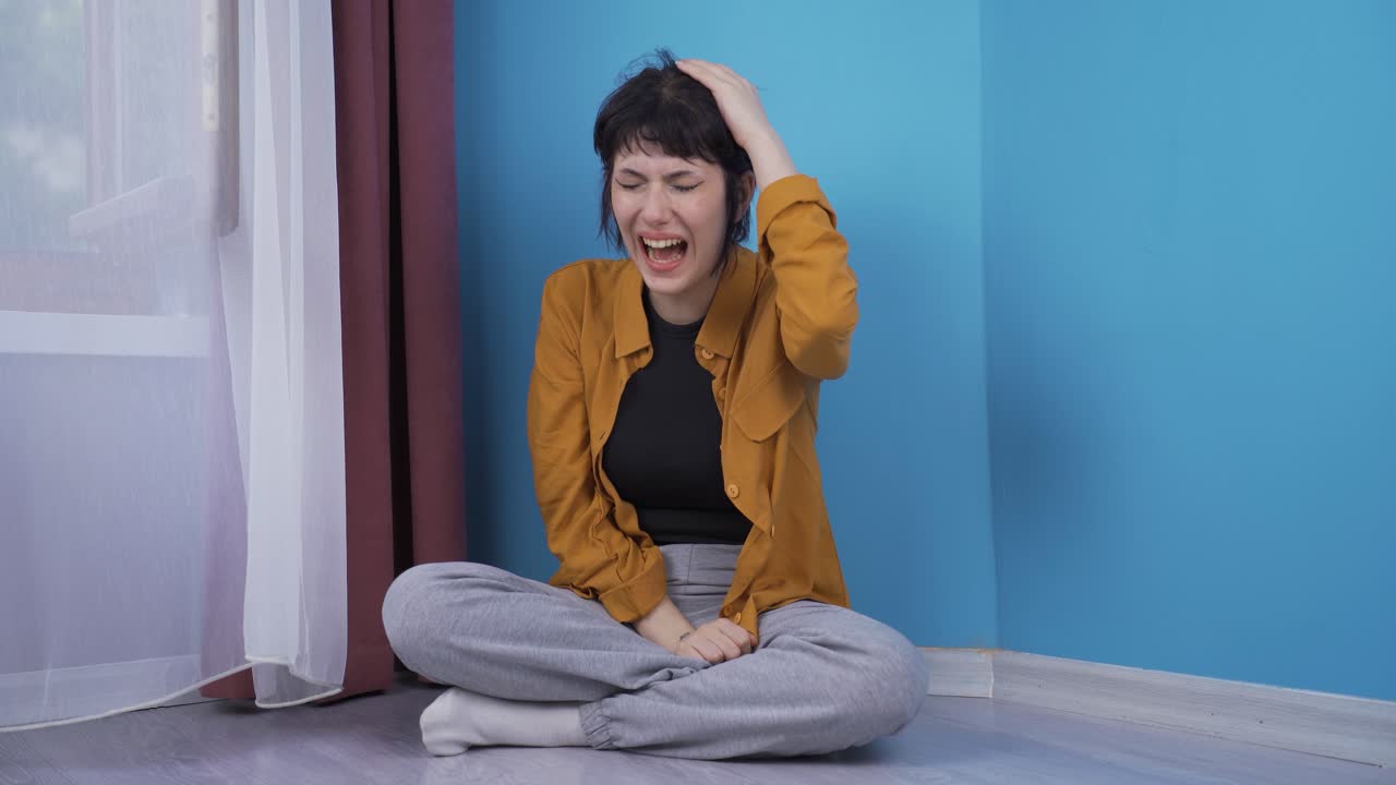 The screaming young woman is crying. Hysterics.