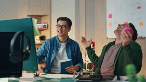 excited creators talking video call computer office closeup. coworkers laughing