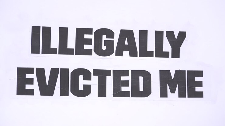 A message on a white cardboard placard says, “Illegally evicted me” on a housing protest opposing eviction during the Coronavirus pandemic