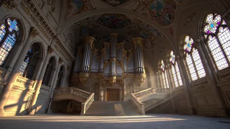 grand church interior with organ and stained glass windows