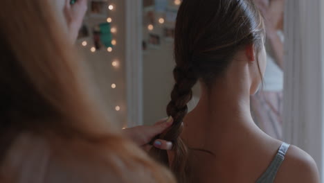 happy-girl-friends-hanging-out-together-at-home-tying-hair-making-braids-enjoying-friendship-having-fun-posing-for-photo-relaxing-in-bedroom-on-weekend