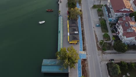 flying and discovering fethiye city waterfront with parked boats and houses in turkey