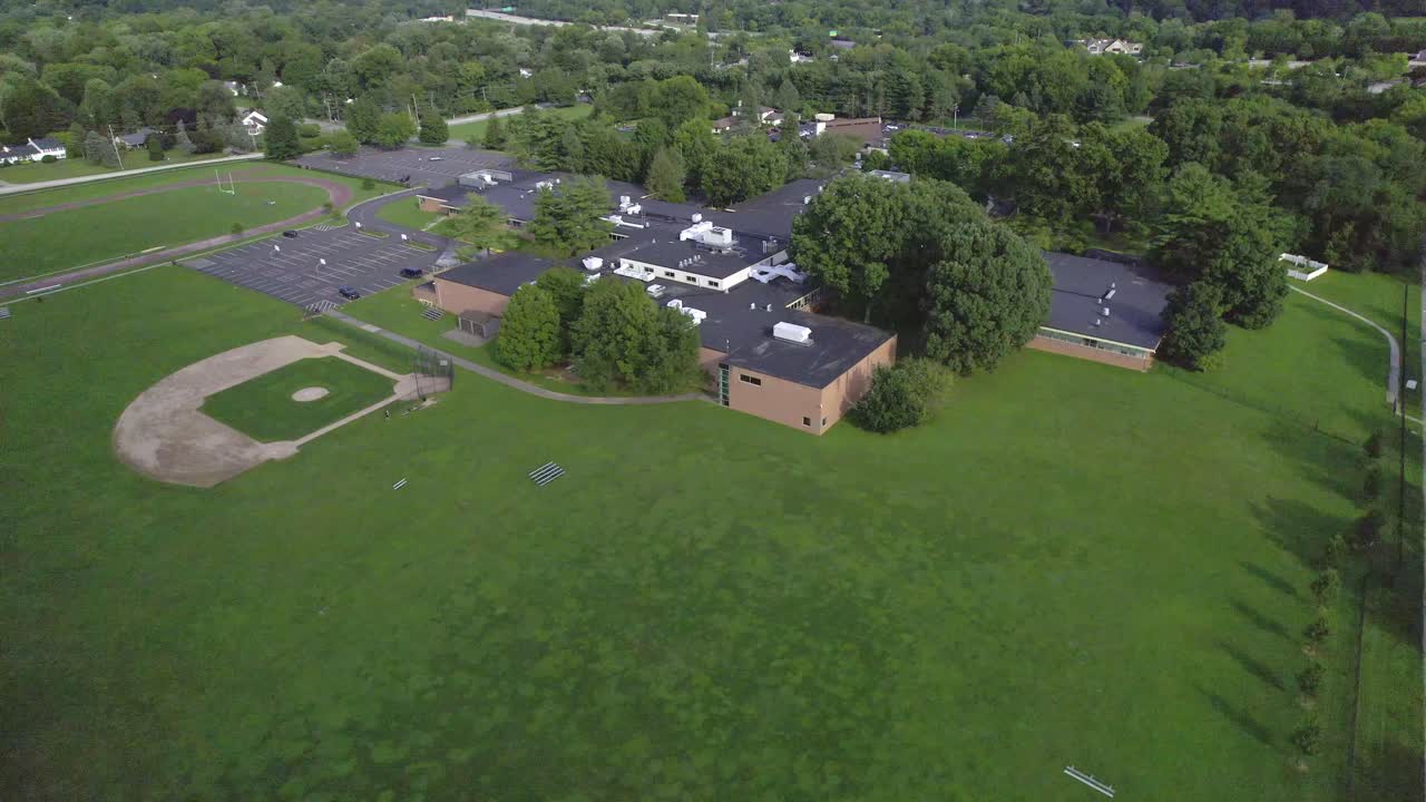 Aerial View of School Campus with Baseball Field and Running Track