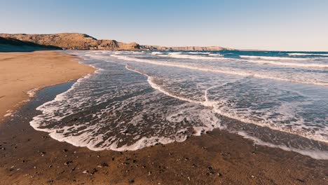 sea wave moving on the sand beach in patagonia slowmotion