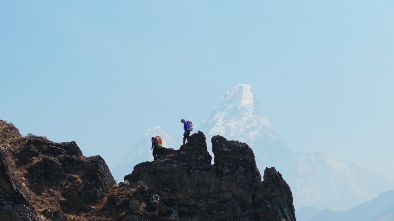 Two tourists hike rocky trails from Phortse to Dingboche, Everest Base Camp trek. Dreamy Mount Everest peeks through soft clouds, stunning scenery adventurous Tourism and travel Nepal