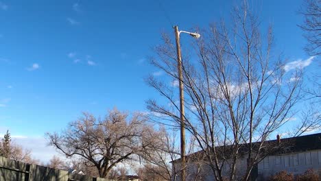 timelapse - clouds moving over the top of a building in a small town during the day