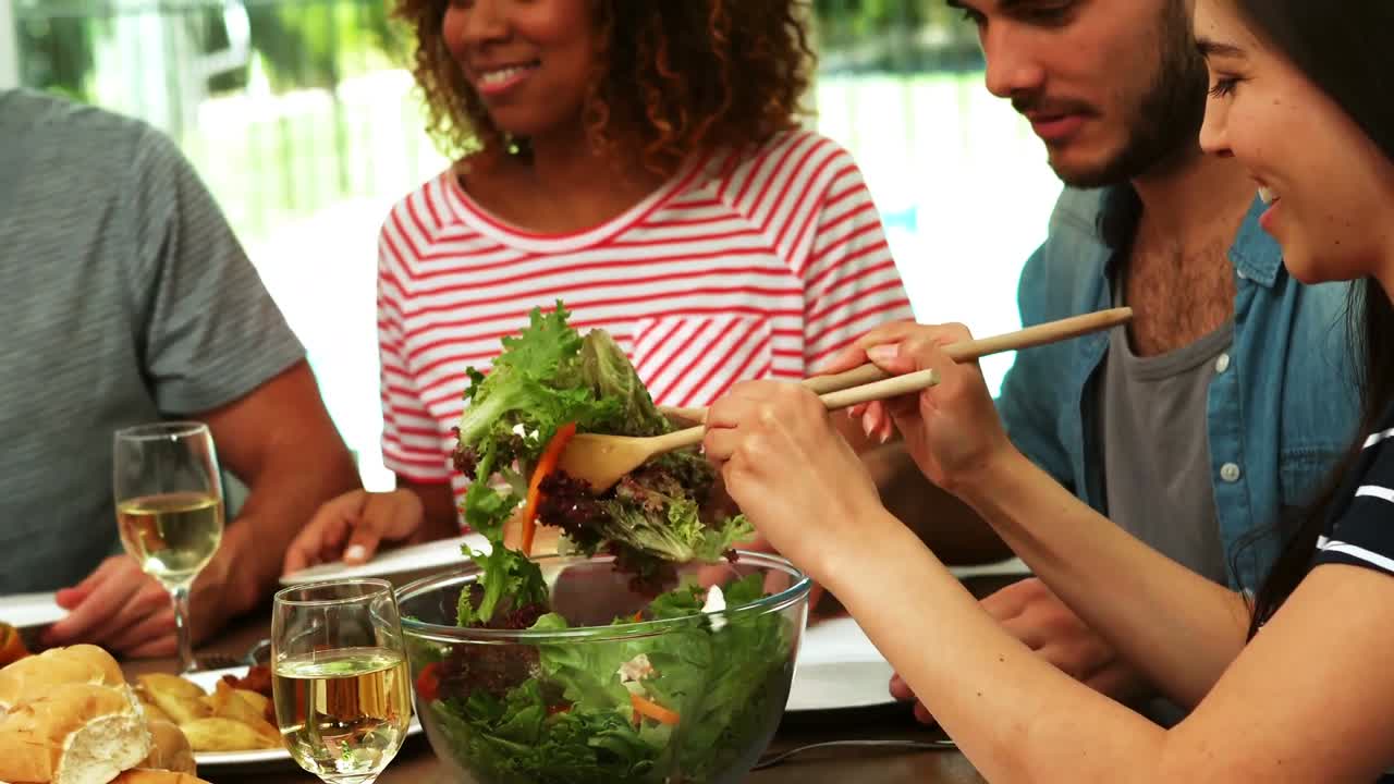 Happy friends eating salad