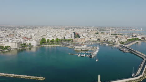 aerial footage flying over a marina and circolo canottieri barion sporting club in old city bari, italy