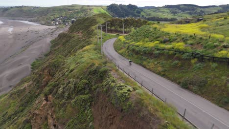 cyclists pedaling at high speed through matanzas, navidad commune, ohiggins region, chile