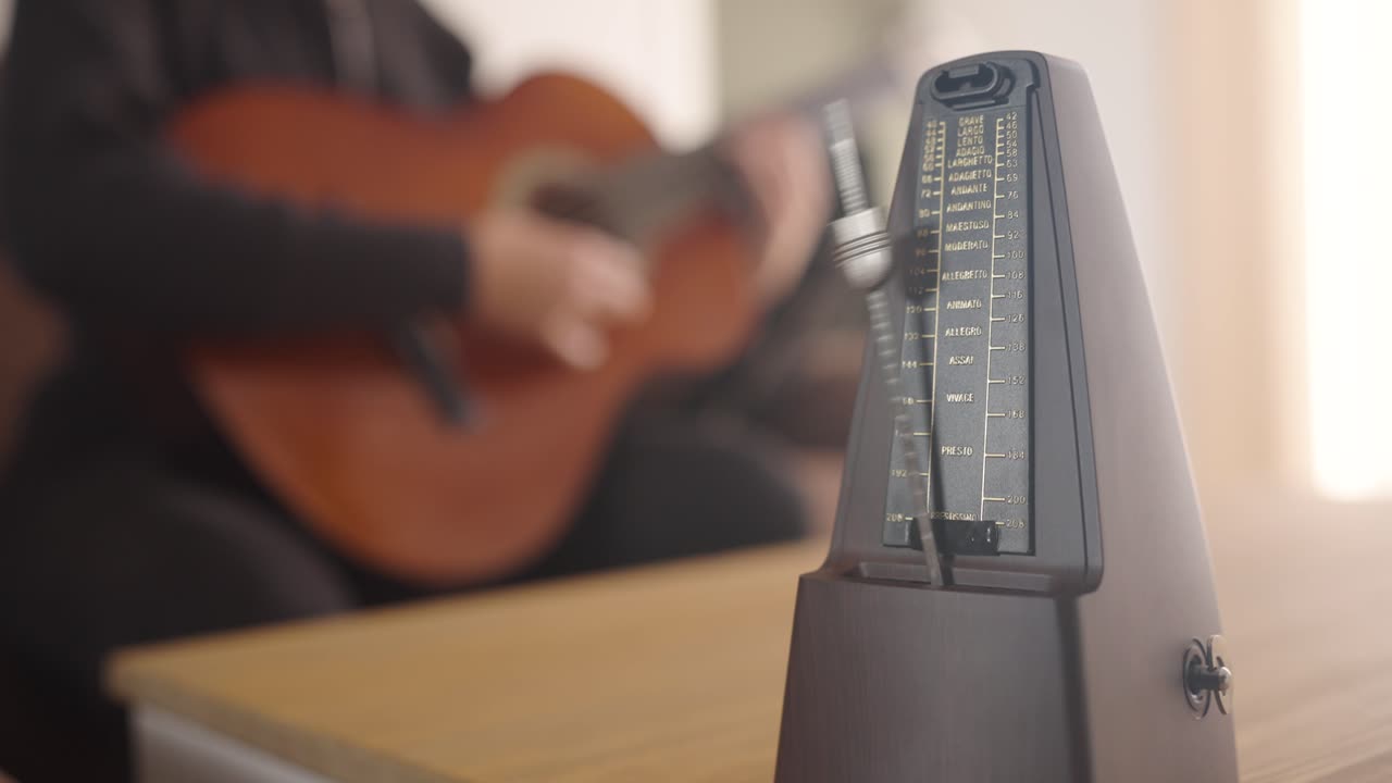 Metronome and guitarist creating harmonious rhythm together