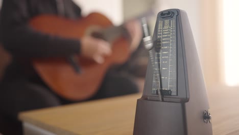 metronome and guitarist creating harmonious rhythm together