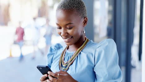 Typing,-phone-and-black-woman-laughing-in-office