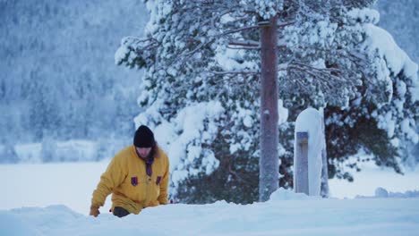 man walking up pulling classic snow plow in winter