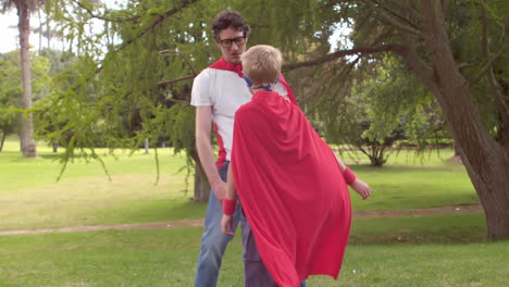 father and son pretending to be superhero