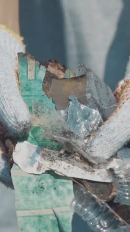 volunteer cleans plastic waste from beautiful bali beach