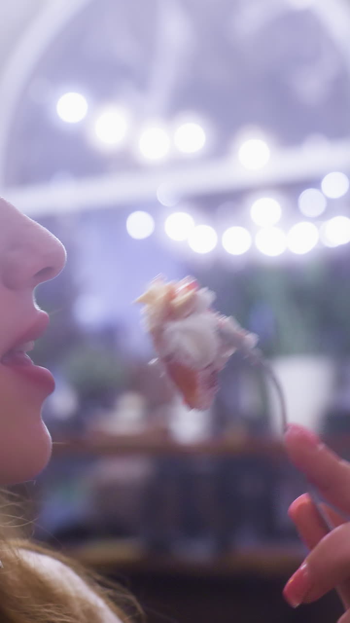 Cheerful lady in cozy cafe enjoying creamy croissant topped with whipped cream and fruit, eating with fork. Relaxed dessert moment captured with soft background and inviting cafe ambiance