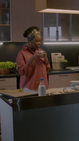 Woman-drinking-coffee-in-the-kitchen