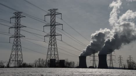 smoke rises from the nuclear power plant at three mile island pennsylvania with power lines foreground 1