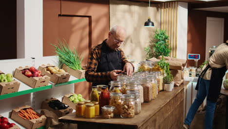 aged worker restocks zero waste store