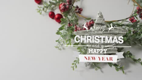 Animation-of-merry-christmas-text-over-christmas-wreath