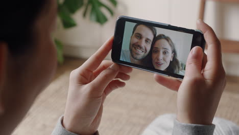 young woman having video chat using smartphone at home chatting to friends enjoying conversation sharing lifestyle on mobile phone